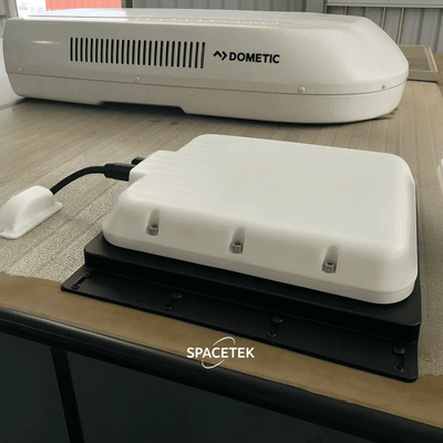 V-Cell rugged enclosure for Starlink Mini, roof-mounted next to Dometic air conditioner on fixed vehicle install